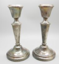 A pair of silver candlesticks, 142mm