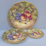 A set of three graduated Royal Worcester hand painted cabinet plates, decorated with fruit, signed