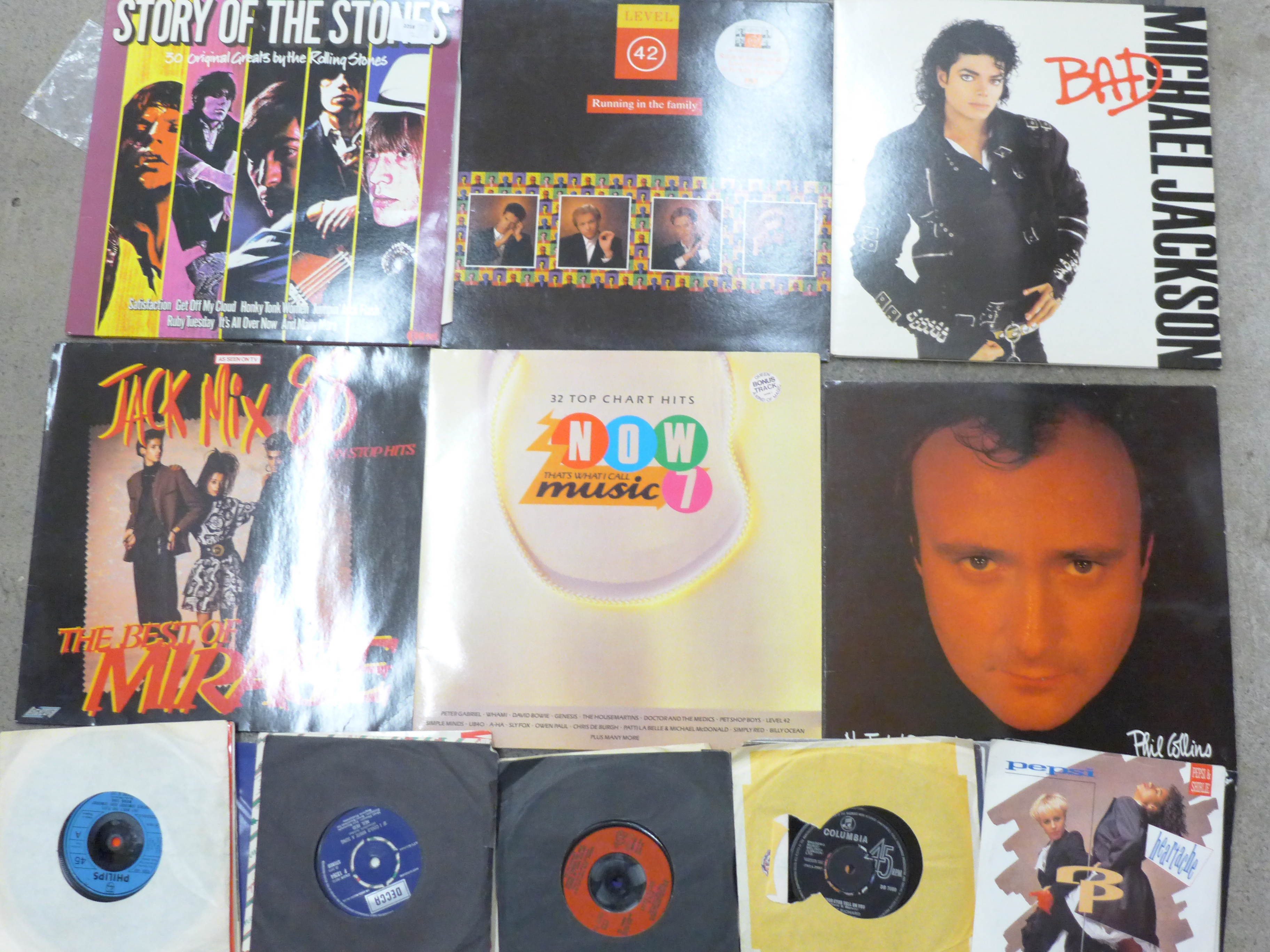 A collection of mainly 1970s and 1980s LP records including Story of The Stones and 7" singles