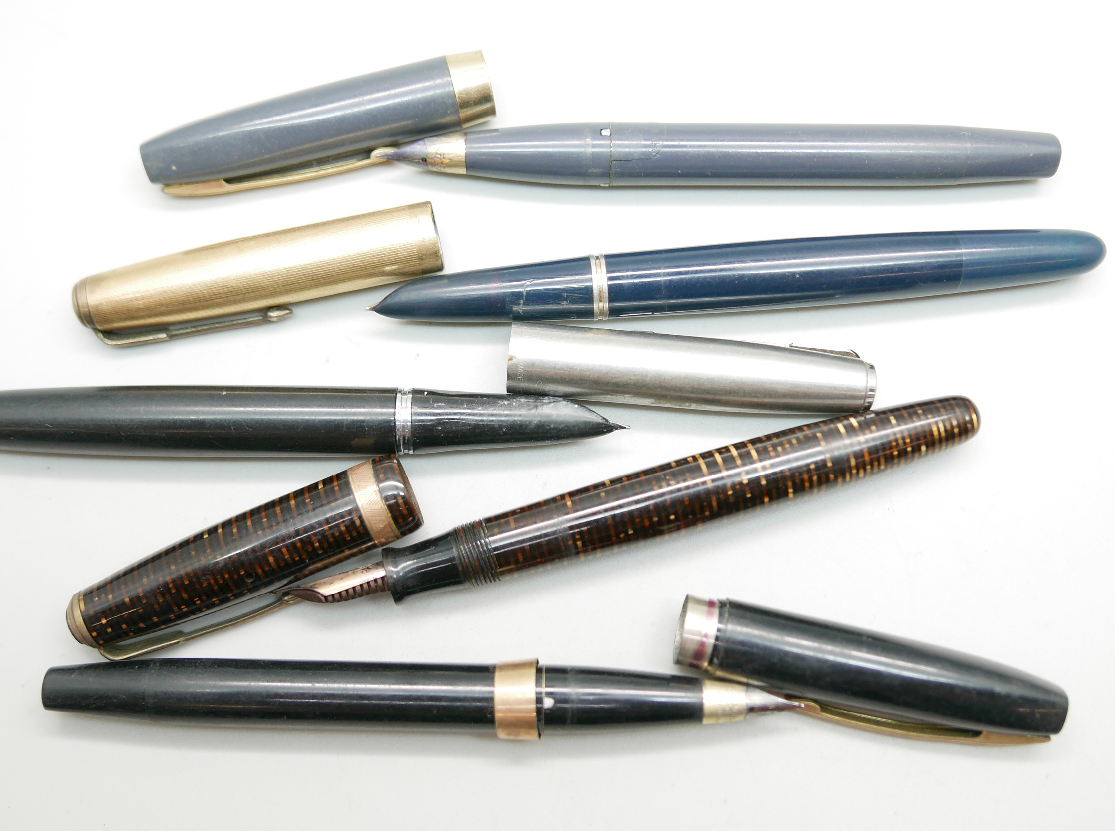 Three Parker fountain pens and two Sheaffer fountain pens