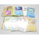 A collection of British Pokemon cards, some in protective sleeves, some loose