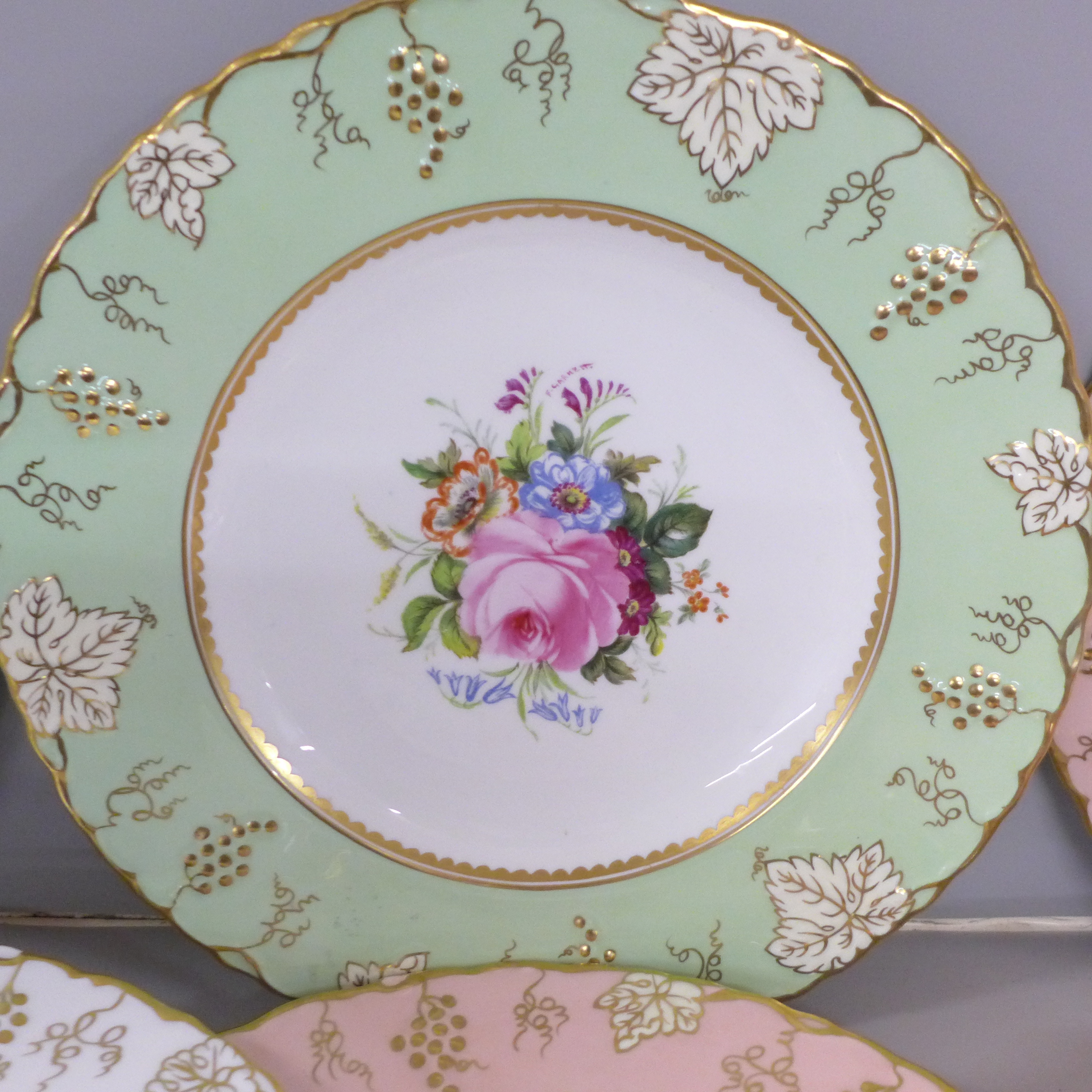 Three pink, one white and one green Royal Crown Derby vine pattern plates with hand painted floral - Image 2 of 8