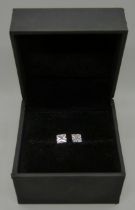 A pair of 9ct white gold and simulated diamond stud earrings