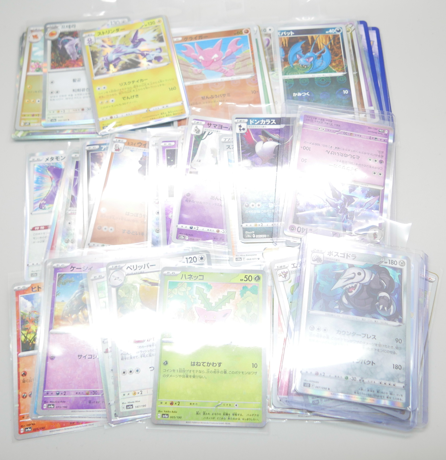 A collection of Japanese Pokemon cards in protective sleeves