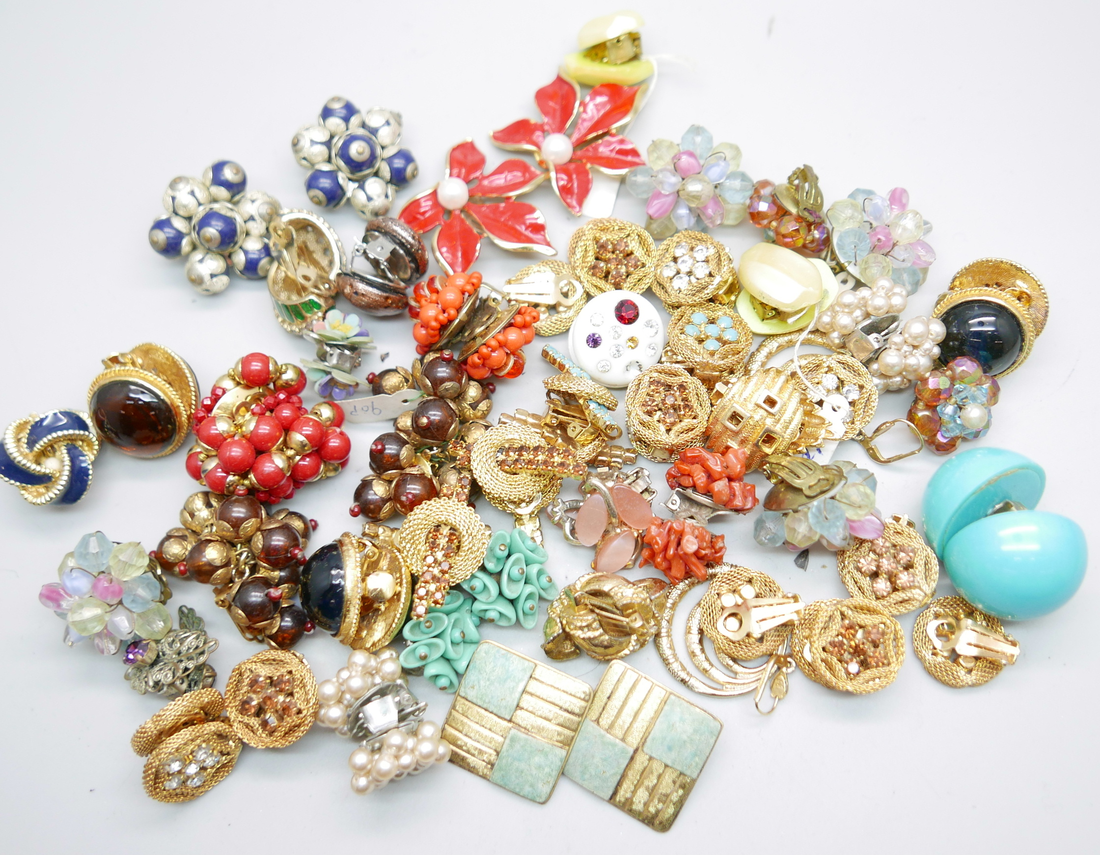A collection of vintage clip-on earrings and a pair of coral earrings