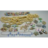 A collection of brooches and four shell necklaces