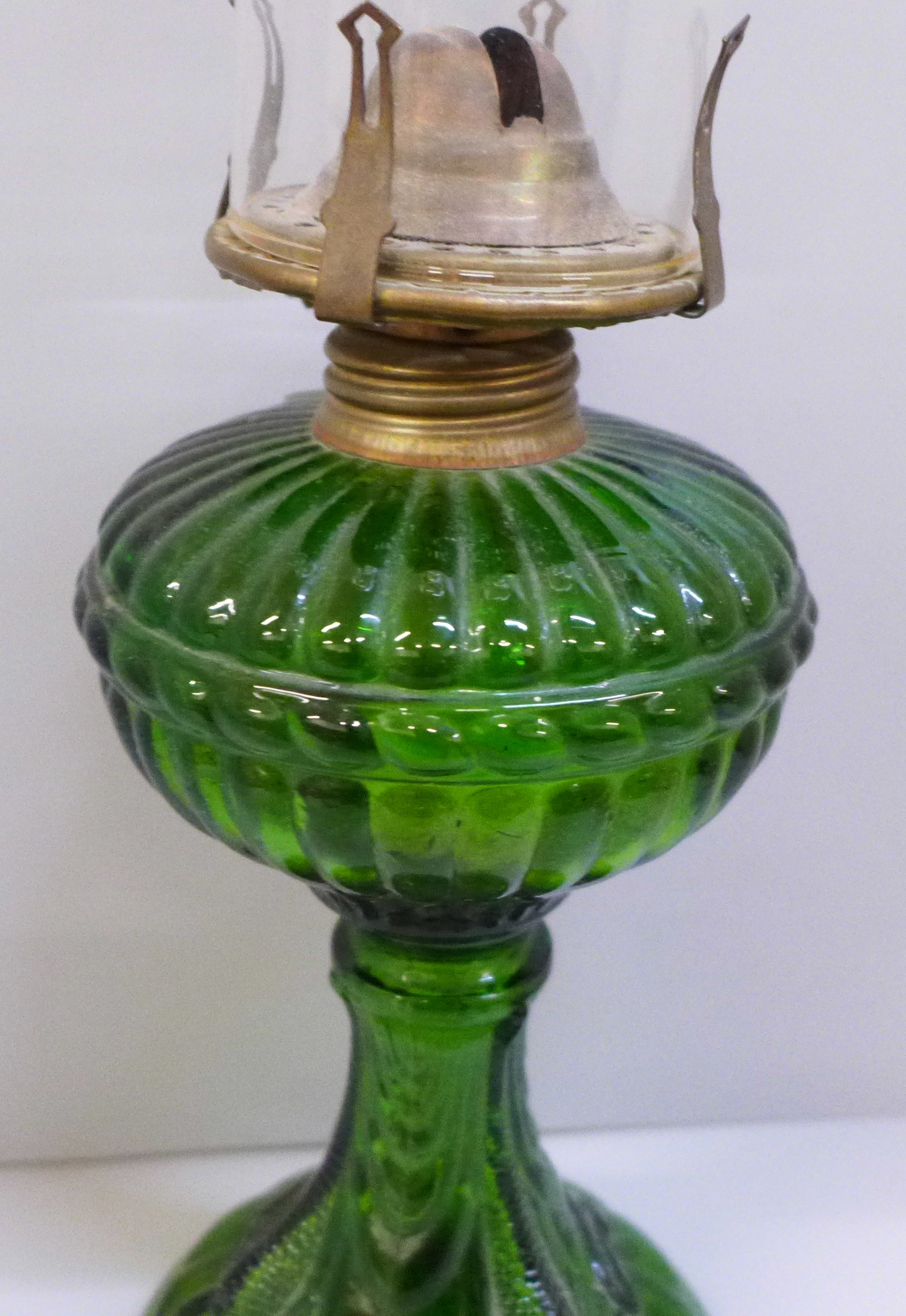 An oil lamp, green glass base with fish detail and original glass chimney - Image 2 of 2