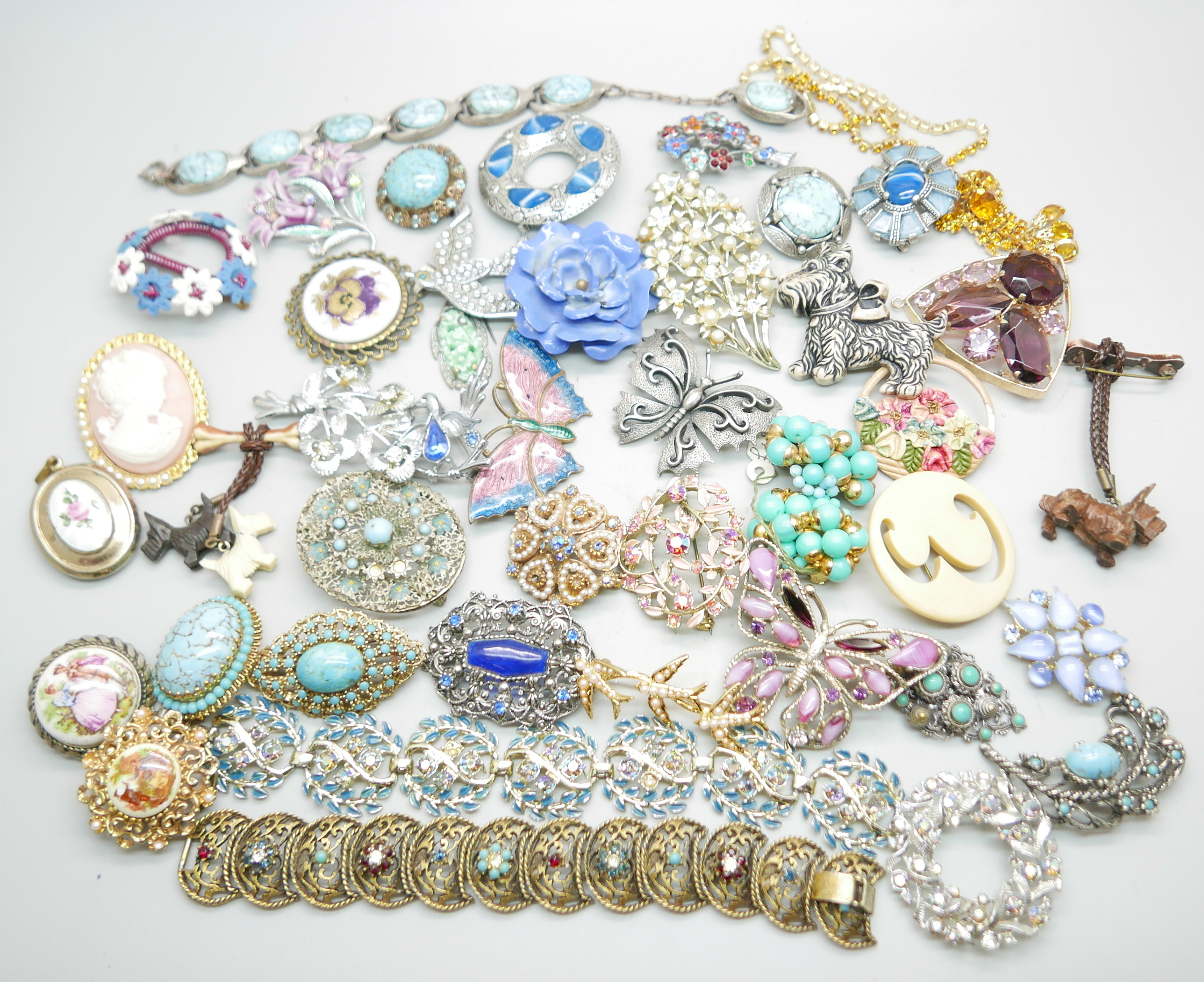 A collection of brooches, a necklet and a bracelet, a early plastic carved celluloid 'dangly'
