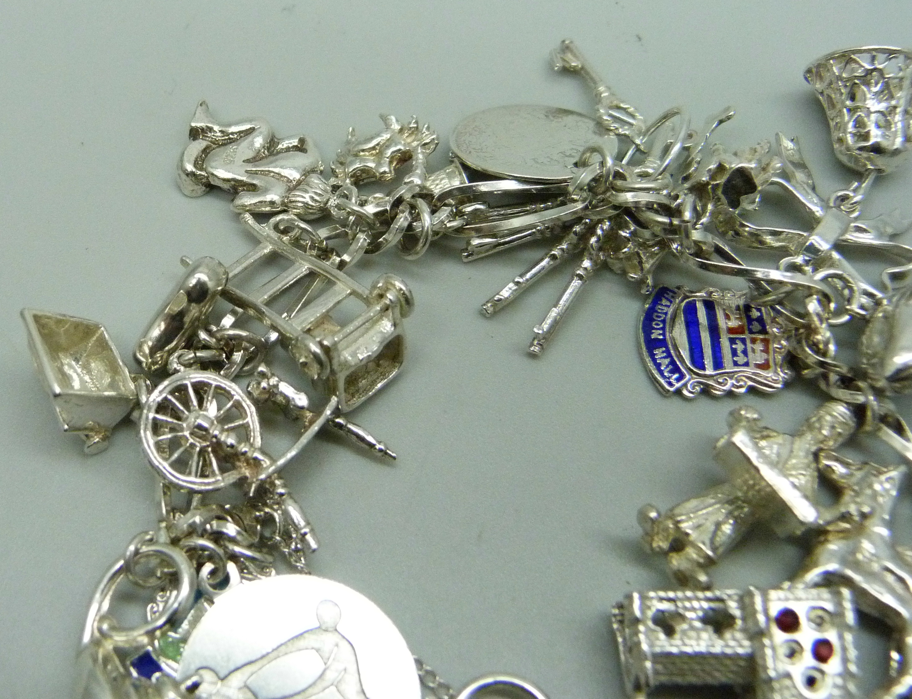 A silver charm bracelet with 26 charms, 63.9g - Image 3 of 3