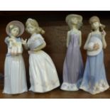 Four Lladro figures of young girls, three with bonnets and one holding a box of flowers