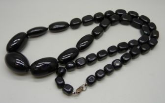 A large heavy black bead necklace with silver fastener, possibly obsidian, length 85cm, 276g