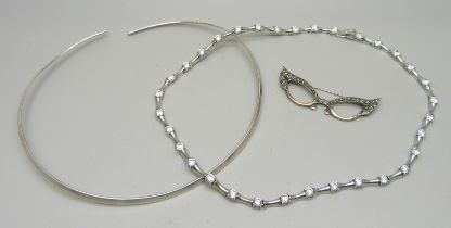 A silver and clear stone necklace, a torque silver necklace and a novelty silver brooch