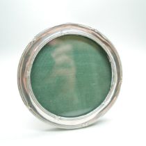 A circular silver photograph frame, 10.5cm