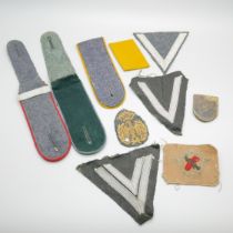 A selection of German uniform cloth badges and epaulettes