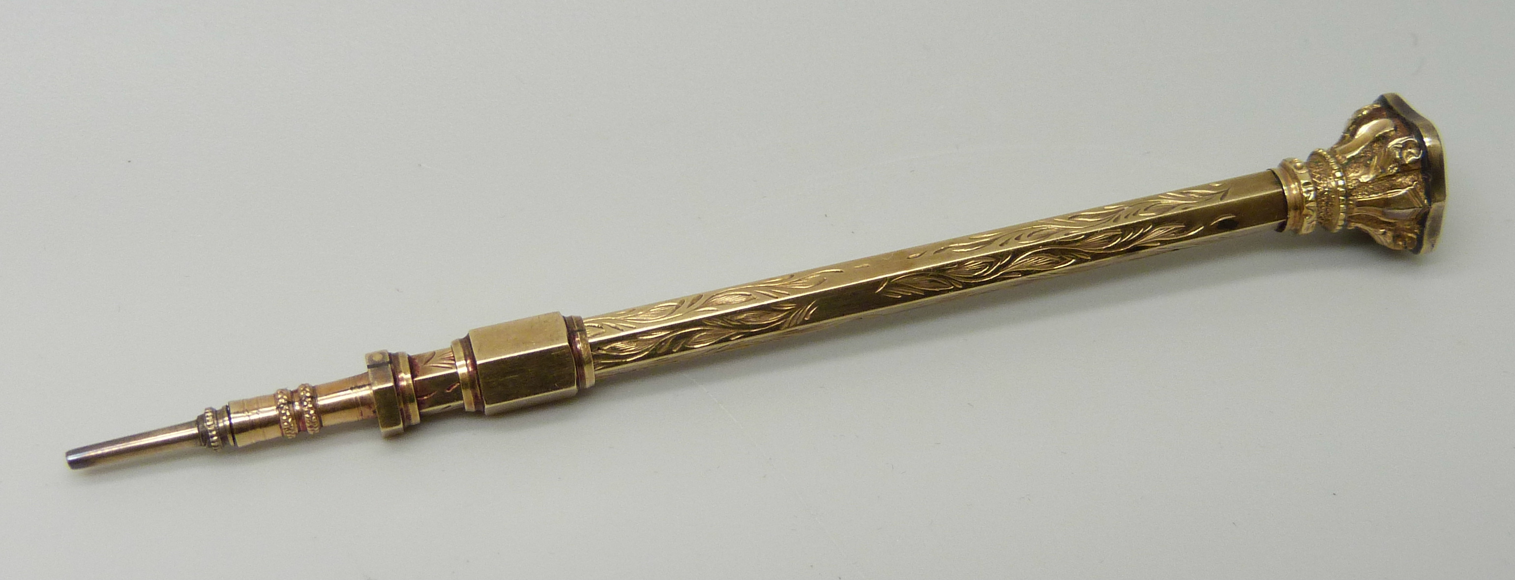 A gold tone propelling pencil with agate stone detail