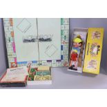 A Pinocchio Pelham puppet and a vintage Monopoly game