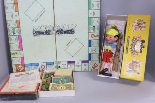 A Pinocchio Pelham puppet and a vintage Monopoly game