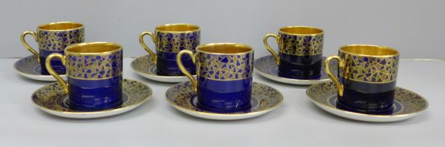 A set of six Crown Devon Art Deco royal blue and gold coffee cans and saucers, crazing to base of