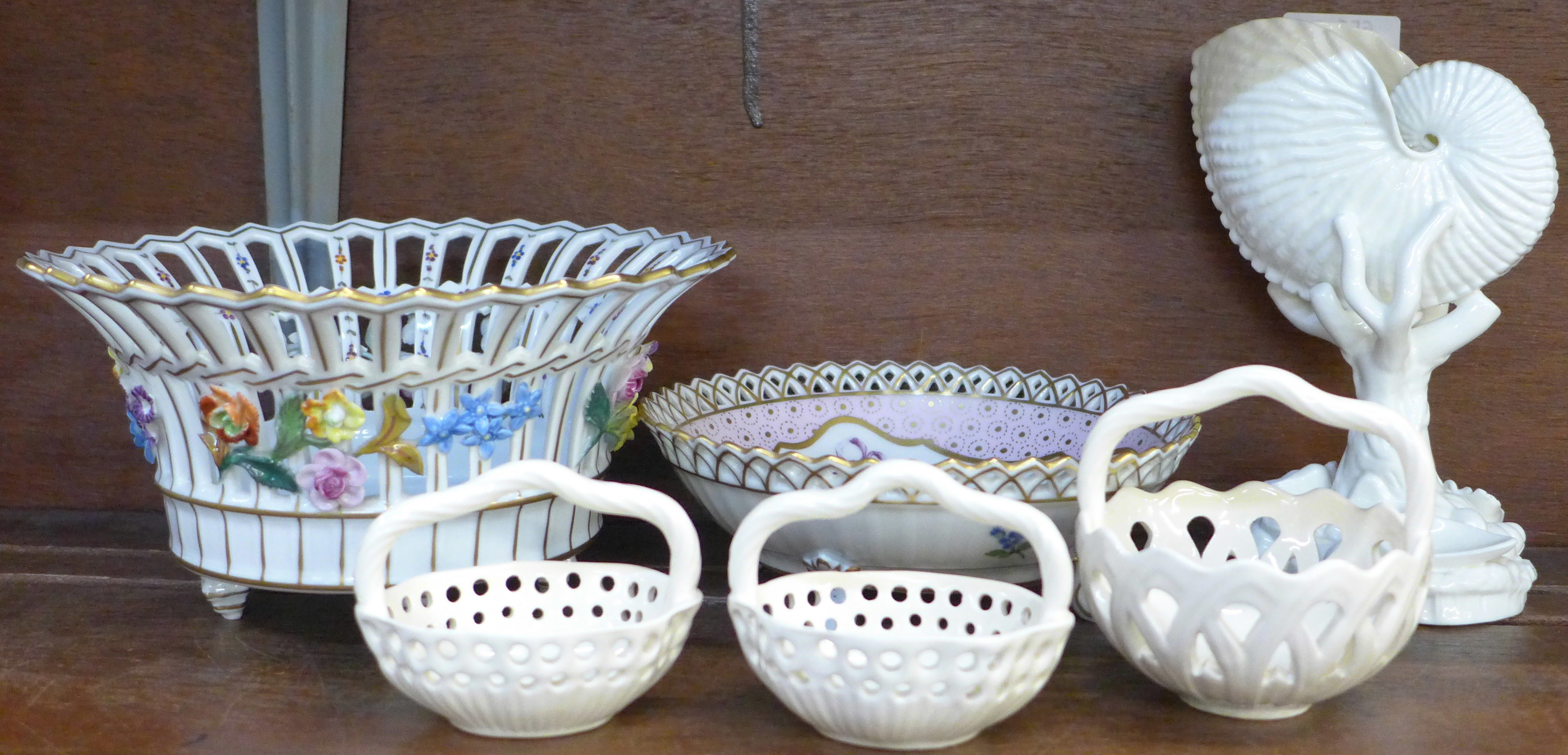 A Royal Worcester porcelain nautilus vase, 17cm, three Royal Creamware baskets and two Dresden