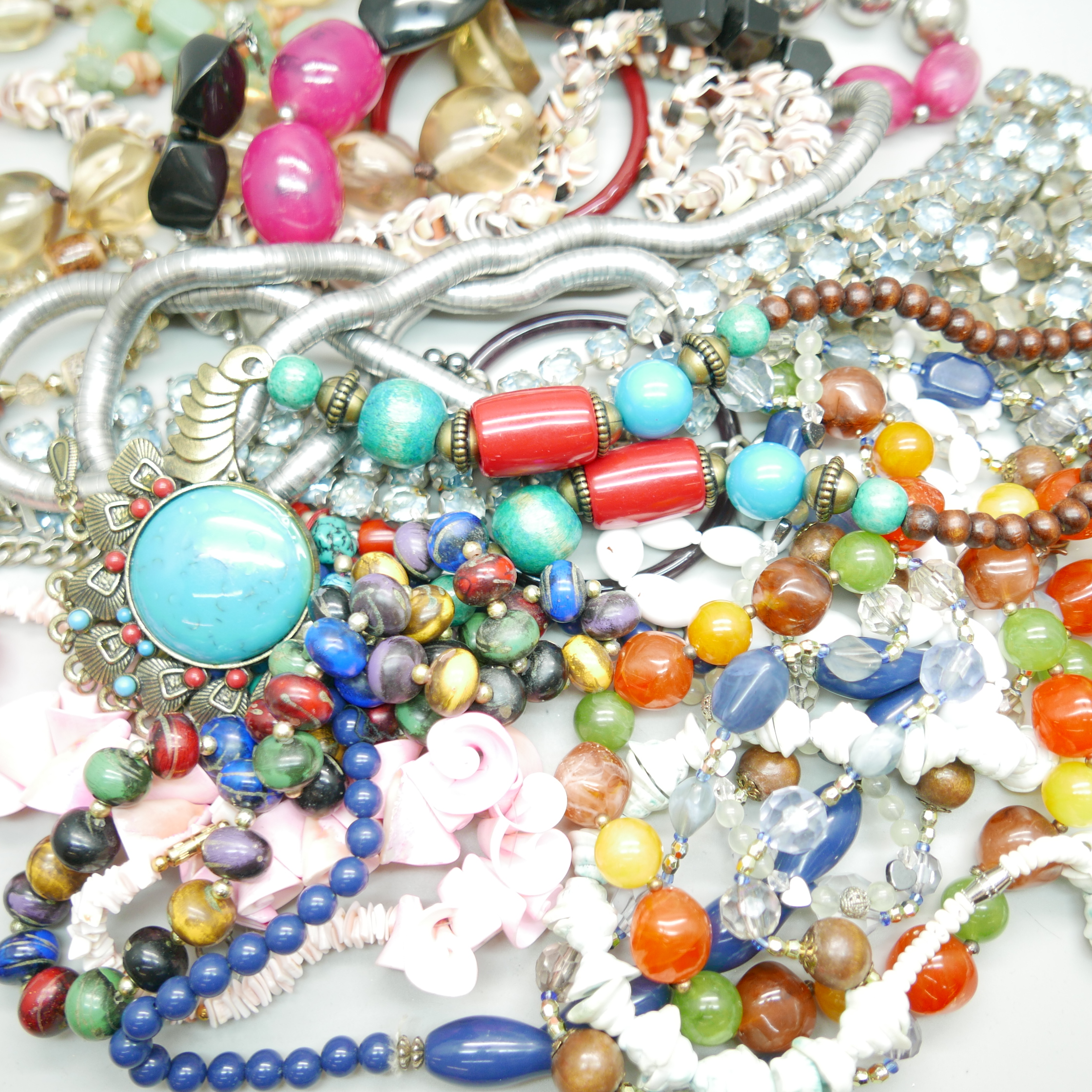 A bag of assorted costume jewellery, blue rhinestone set belt, glass bangles, shell necklaces, - Image 2 of 2