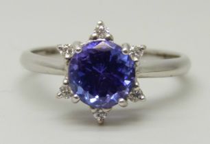 An 18ct white gold ring set with a round AAA grade tanzanite and six small round facet cut diamonds,