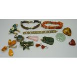 A collection of jewellery including an agate and a tigers eye bracelet, three jade pendants, a