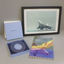 A framed print of Concorde, an in-flight Concorde dinner menu and an in-flight gift from Concorde