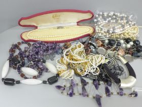 A collection of costume jewellery including gemstones, pearls with a silver clasp, etc.