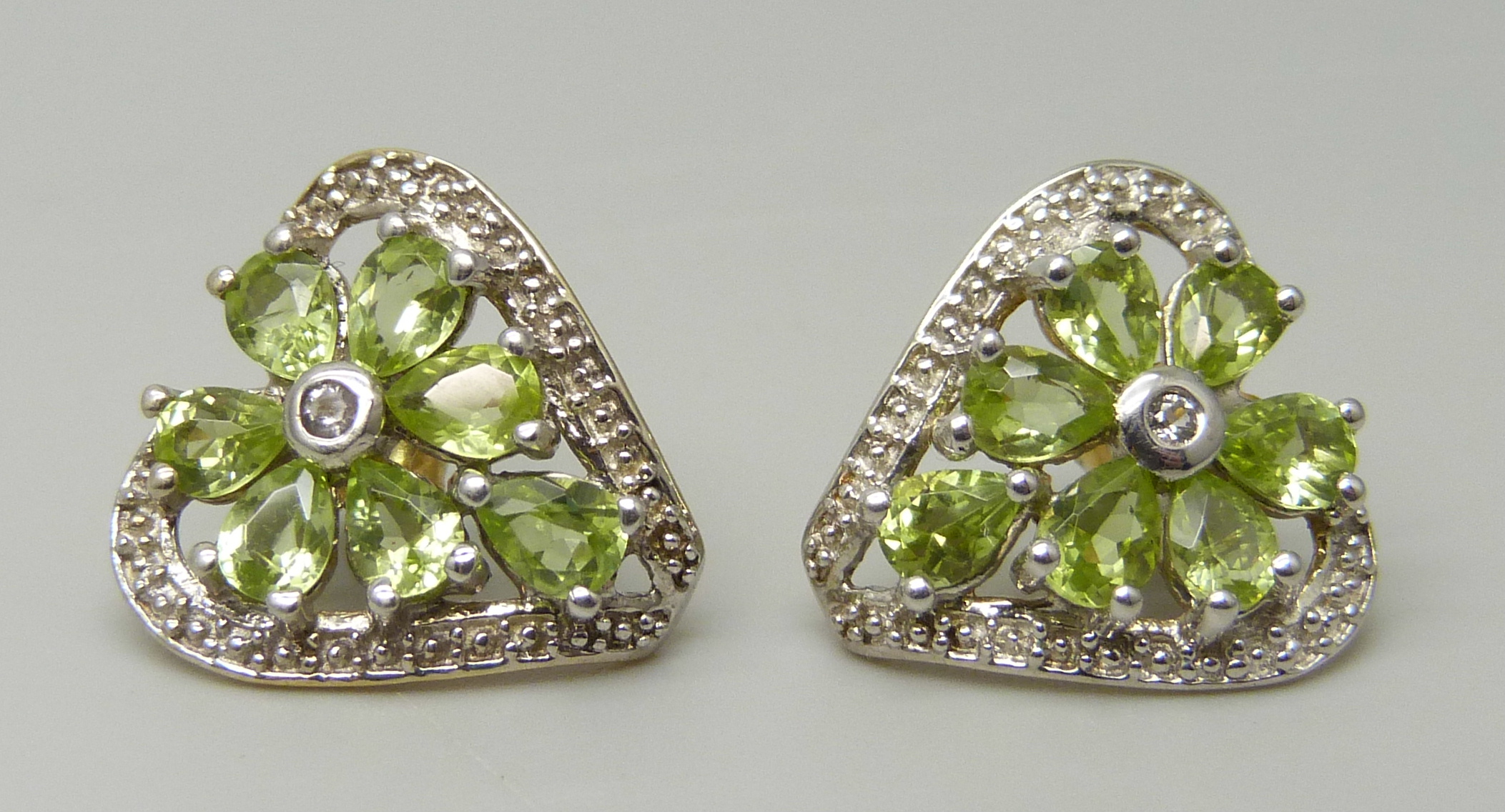 A pair of silver gilt, peridot and white topaz earrings