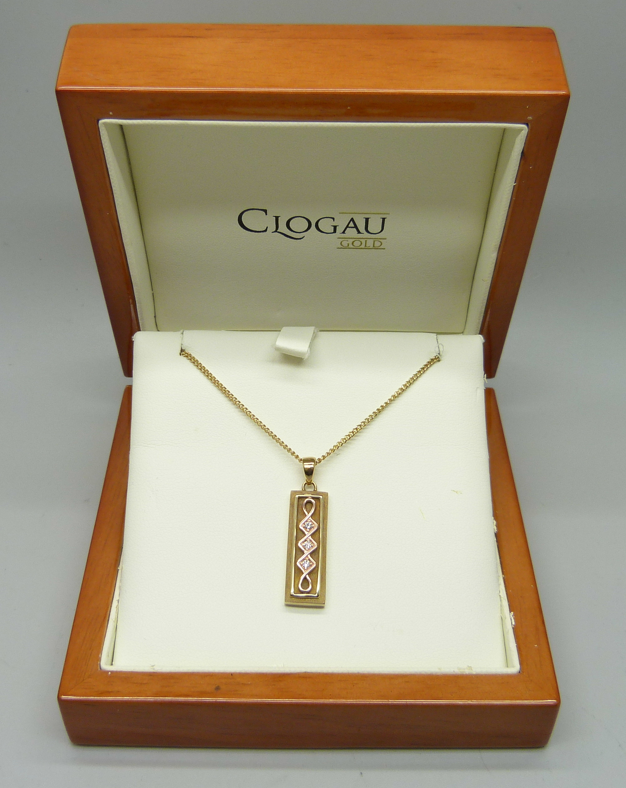 A limited edition Clogau Welsh 9ct gold ingot style pendant of Celtic design, set with three small