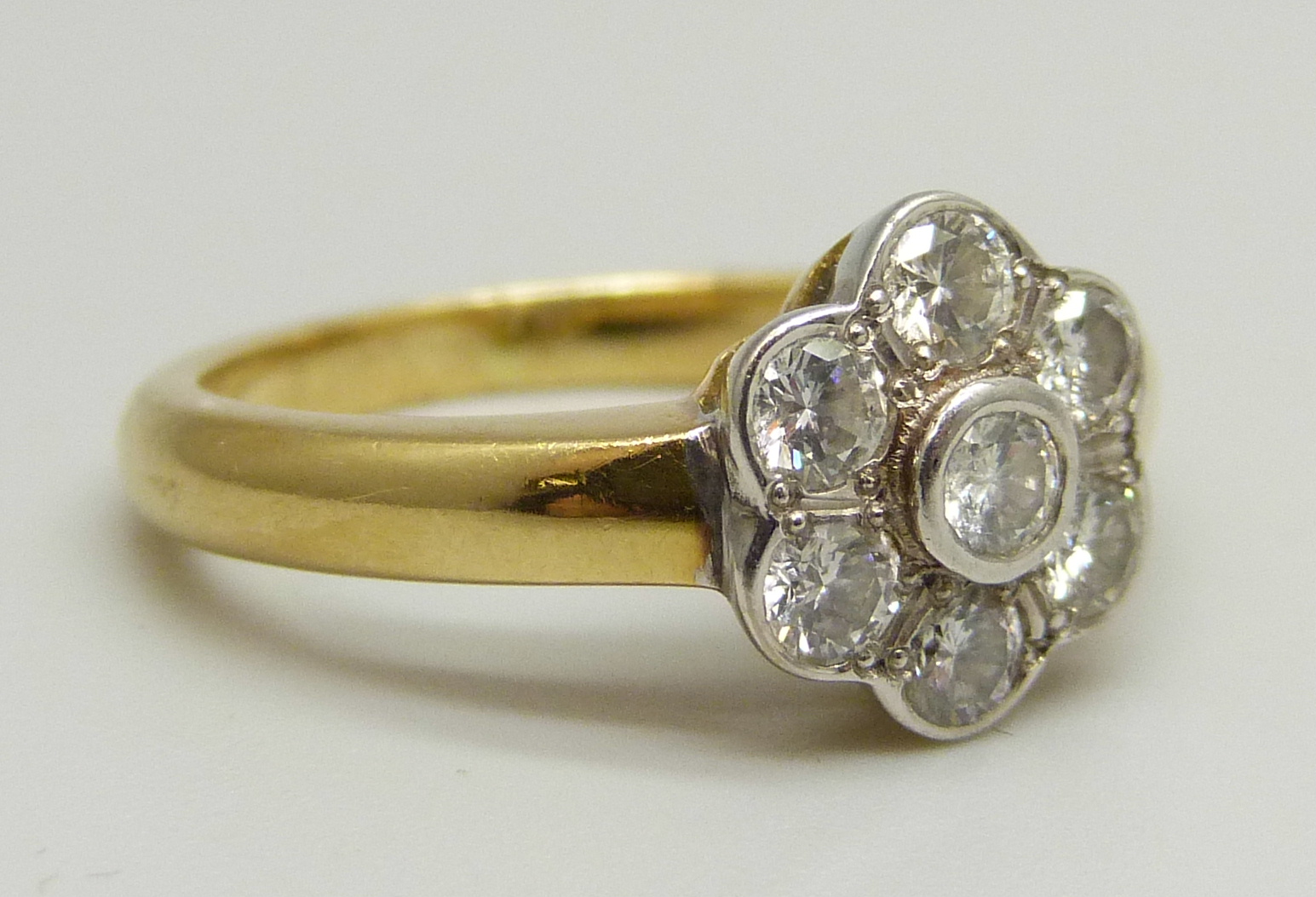 An 18ct yellow gold daisy cluster ring set with seven round brilliant cut diamonds, approximately - Image 3 of 4