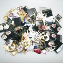 A collection of cloisonne jewellery, earrings and brooches, an embossed gold and silver tone