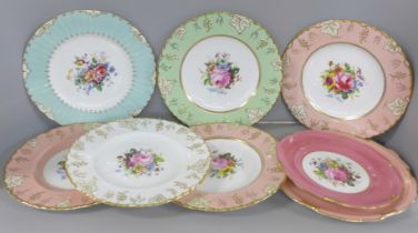 Three pink, one white and one green Royal Crown Derby vine pattern plates with hand painted floral