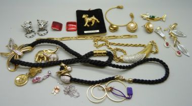 A collection of gold tone jewellery including, dog, dolphin and elephant brooches and a pair of