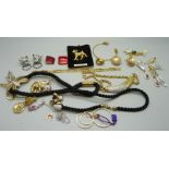 A collection of gold tone jewellery including, dog, dolphin and elephant brooches and a pair of