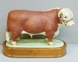 A Royal Worcester figure of a Hereford Bull, 0383H backstamp, on a wooden stand
