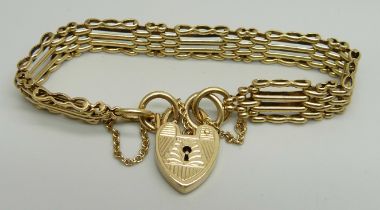 A 9ct yellow gold gate bracelet with engraved padlock clasp and safety chain, 19cm, 20.6g