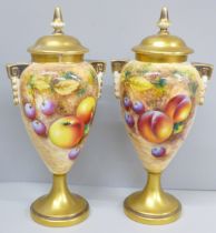 A pair of Royal Worcester hand painted vases and covers, decorated with fruit, signed, one vase