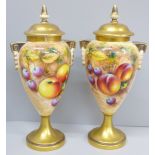 A pair of Royal Worcester hand painted vases and covers, decorated with fruit, signed, one vase