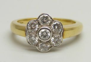 An 18ct yellow gold daisy cluster ring set with seven round brilliant cut diamonds, approximately