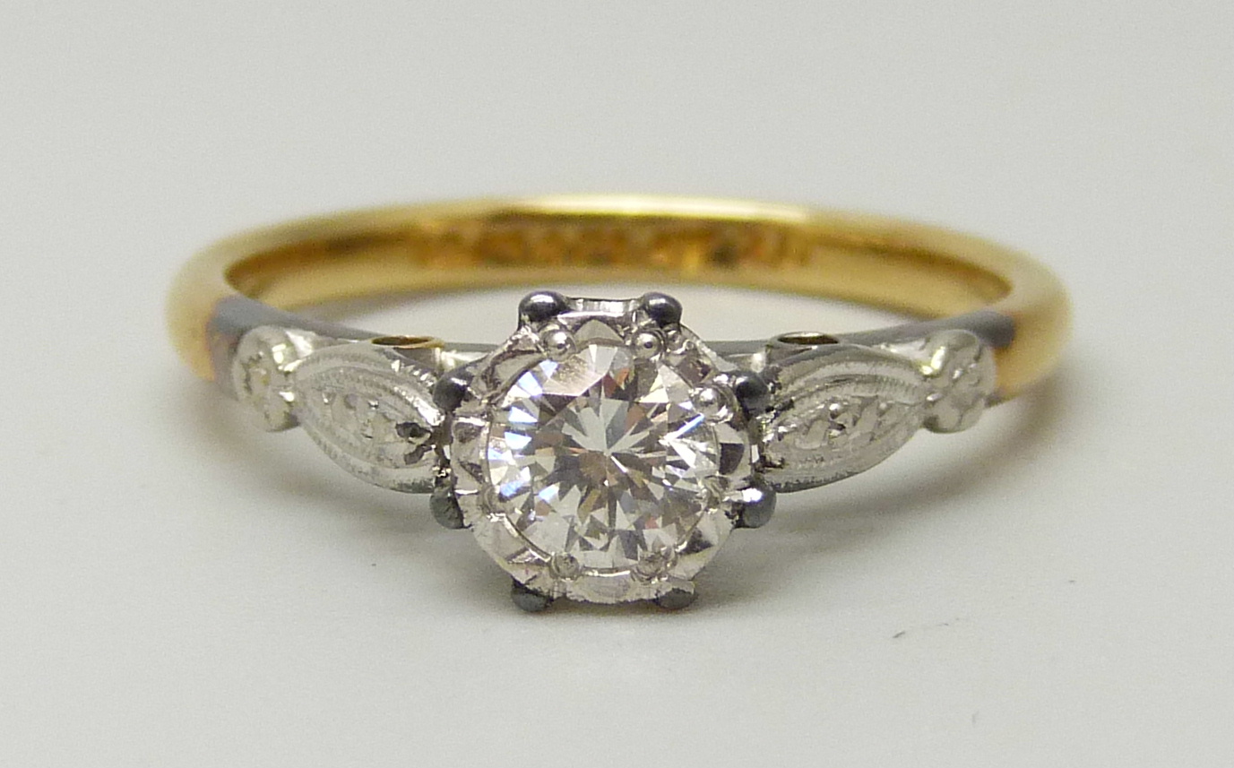 An 18ct yellow gold and platinum set round brilliant cut diamond solitaire ring, approximately 0.