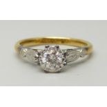 An 18ct yellow gold and platinum set round brilliant cut diamond solitaire ring, approximately 0.