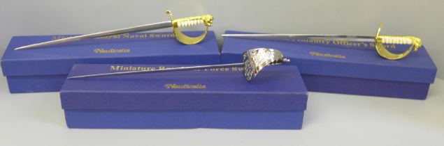 Three Nauticalia Miniature Royal Navy swords, 29cm, boxed