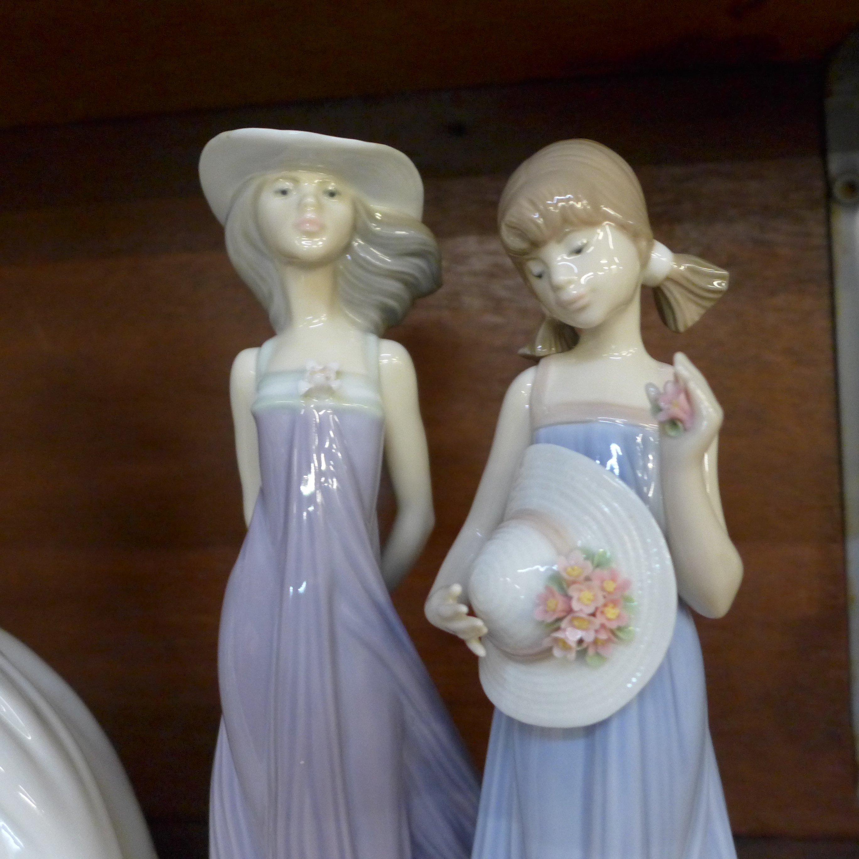 Four Lladro figures of young girls, three with bonnets and one holding a box of flowers - Image 3 of 4
