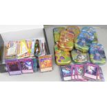 Eight Pokemon tins, Yu-gi-Oh! gaming cards and a mix of gaming cards