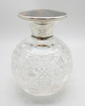 A silver topped globular glass scent bottle