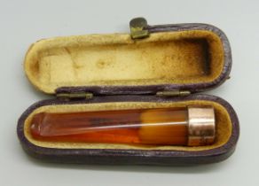 A cheroot holder with a 9ct gold mount, cased, case a/f