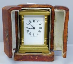 A small brass and four glass sided carriage clock with French movement, inscription to case top in a