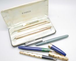 A Parker 1/10 12ct rolled-gold pen and pencil set, personalised, cased, two other Parker pens and