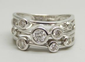 A 9ct white gold abstract design ring set with eight round brilliant cut diamonds, approximately 0.